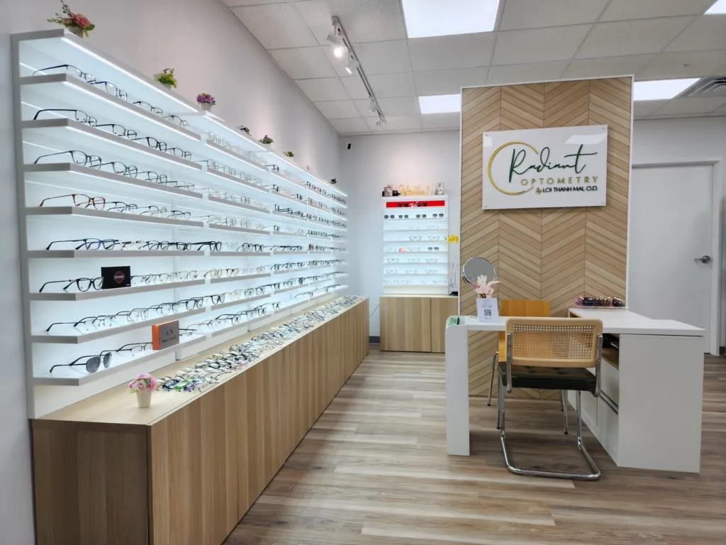 Eyeglass frame wall and Radiant Optometry sign in the optical shop in Bellflower, CA