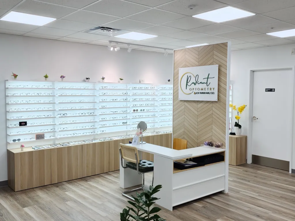 Optician fitting desk and eyeglass frame wall at Radiant Optometry in Bellflower, CA
